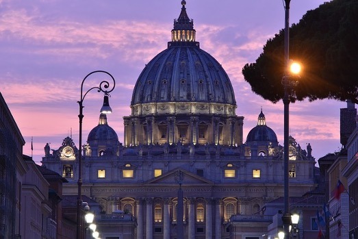 Image of building in Rome during sunset with purple skies.