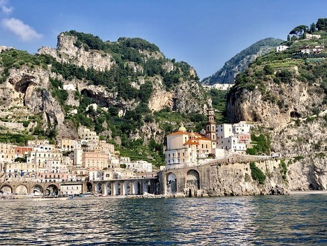 City in the side of a mountain with water at the edge of the city.